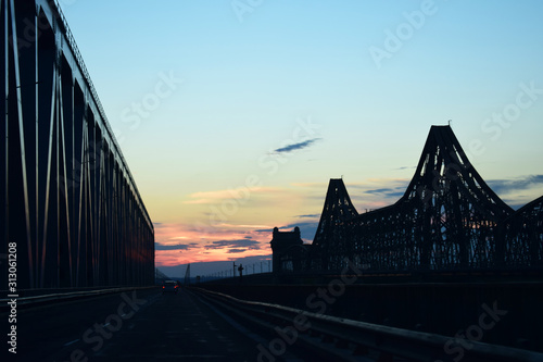 Sunset above an old industrial bridge and highway