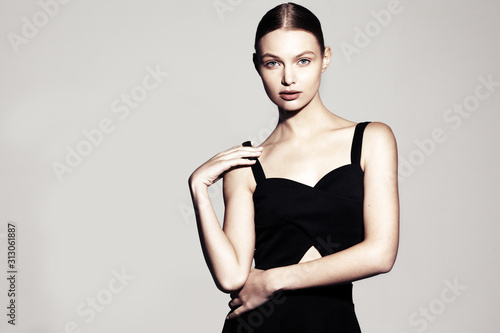 fashion model portrait. beautiful young woman on grey background