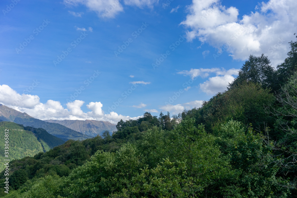 Beautiful mountain landscape on blue sky background with clouds Beautiful mountain landscape on blue sky background with clouds