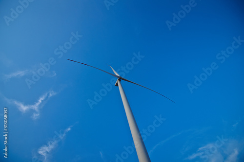 wind turbine against blue sky © Руслан Сушко