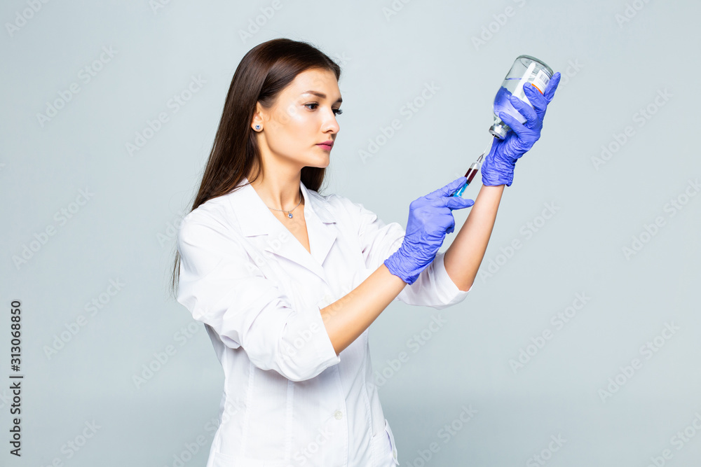 Female doctor with syringe preparation to do a inoculation isolated on white background Female doctor with syringe preparation to do a inoculation isolated on white background
