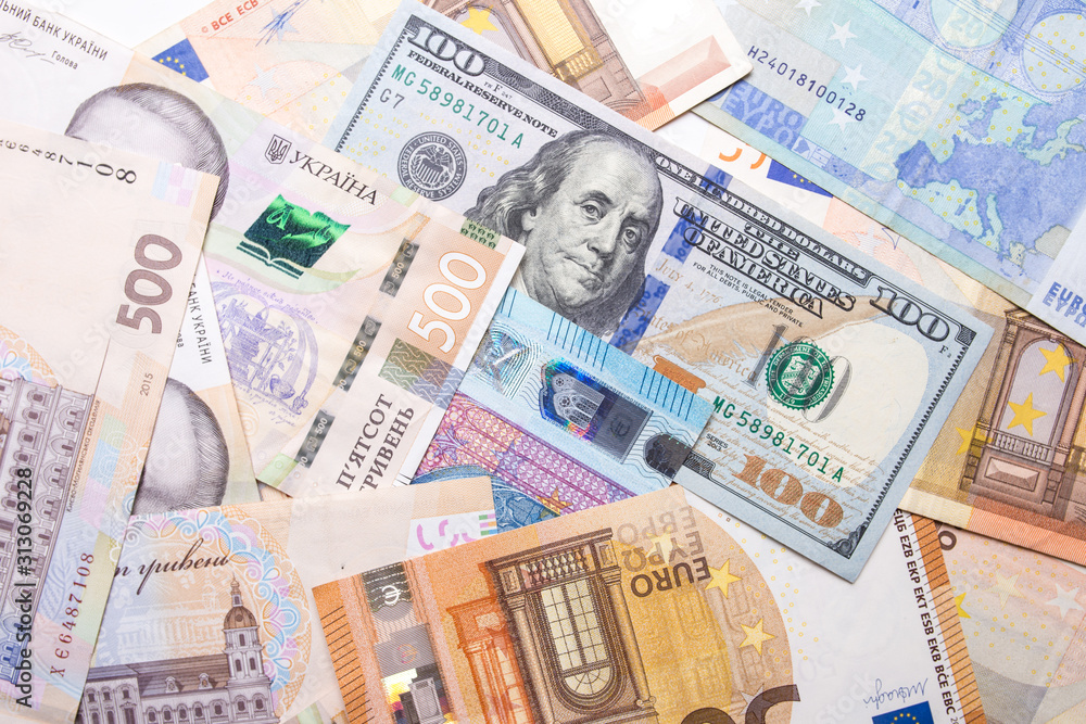 Dollar euro hryvnia closeup. The texture of the currencies of different countries. Dollar euro hryvnia closeup. The texture of the currencies of different countries.