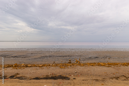 Elton Salt Lake with a pink hue of water and clouds © Nina