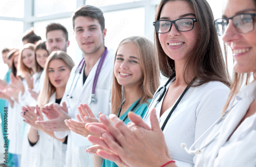 close up. a large group of medical workers applauds close up. a large group of medical workers applauds