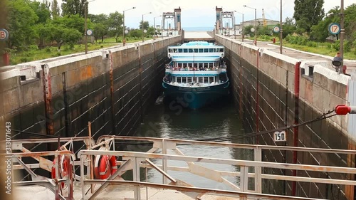 Cruise ship locks on the Dnieper river, Ukraine. Svetlovodsk city. Exit of cruise ship From Sluice. Persenbeug sluice on the  Dnieper river, Ukraine. The sluice door opens.  slowly motion. photo