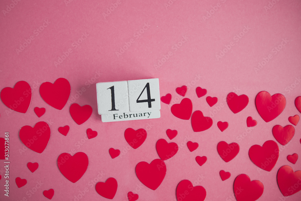 flat lay for february 14: white calendar with the date, pink hearts and place for text on a pink background flat lay for february 14: white calendar with the date, pink hearts and place for text on a pink background