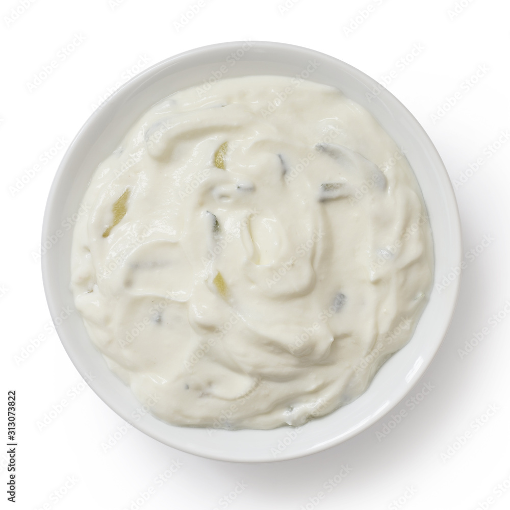 Tzatziki in white ceramic bowl isolated on white from above. Tzatziki in white ceramic bowl isolated on white from above.