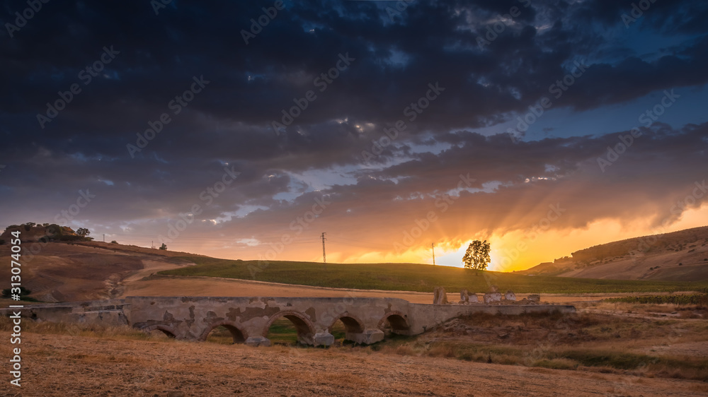 Puesta de sol sobre puente romano