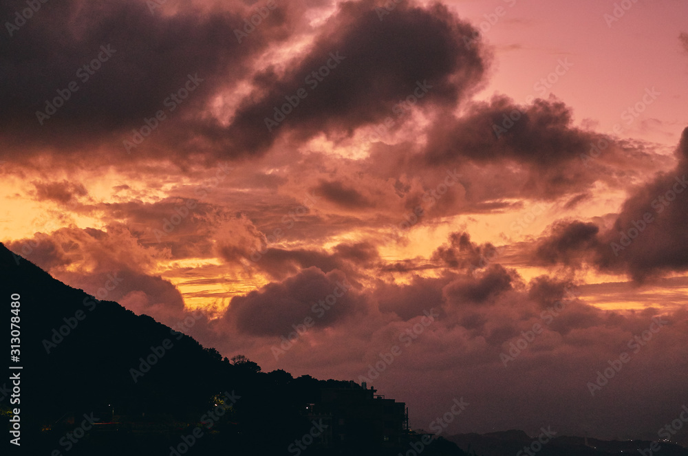 Golden Sun Set in Mountains with Stormy Clouds