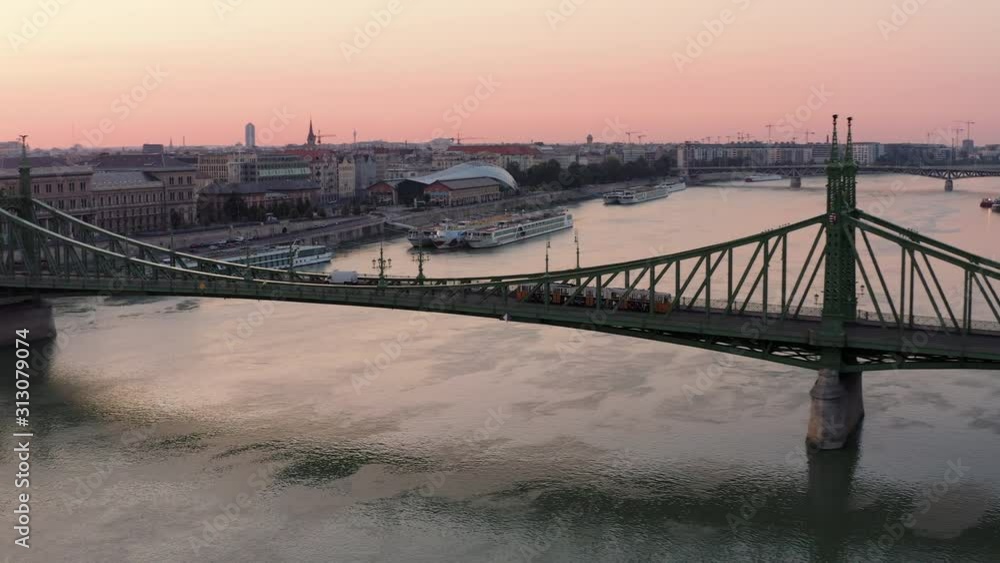 4k Aerial shot of Yellow Tram crossing Danube river on Liberty Bridge at dawn in Budapest, Hungary 4k Aerial shot of Yellow Tram crossing Danube river on Liberty Bridge at dawn in Budapest, Hungary