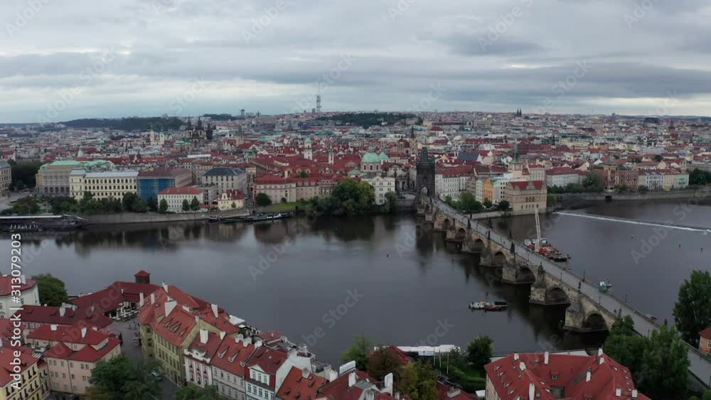 Aerial shot of Prague on cloudy morning- Flying from Lesser Town towards Vltava River and Charles Bridge, Czech Republic Aerial shot of Prague on cloudy morning- Flying from Lesser Town towards Vltava River and Charles Bridge, Czech Republic