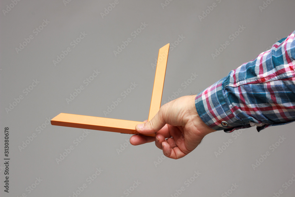 right angle in the hand of an adult right angle in the hand of an adult