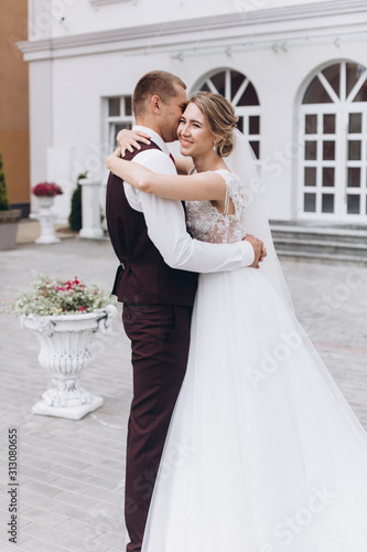 Wedding fashion caucasian couple outdoors in old city background. Beauty, wedding, fashion concept