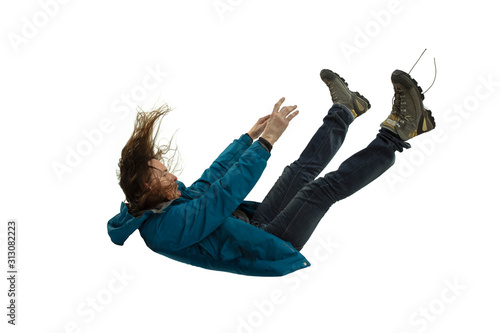 A second before falling. Caucasian young man falling down in moment with bright emotions and facial expression. Male model in casual clothes on white. Shocked, scared, screaming. Copyspace for ad. photo