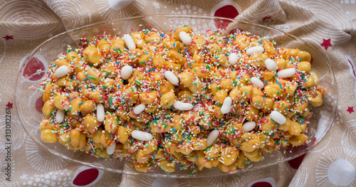 Neapolitan pastry called struffoli - Little shortcrust pastry balls fried dipped in honey photo