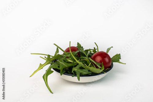 salad of arugula  cherry tomatoes isolated on white background