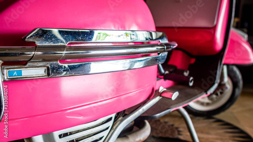 detail of pink scooter with chromed metallic fender