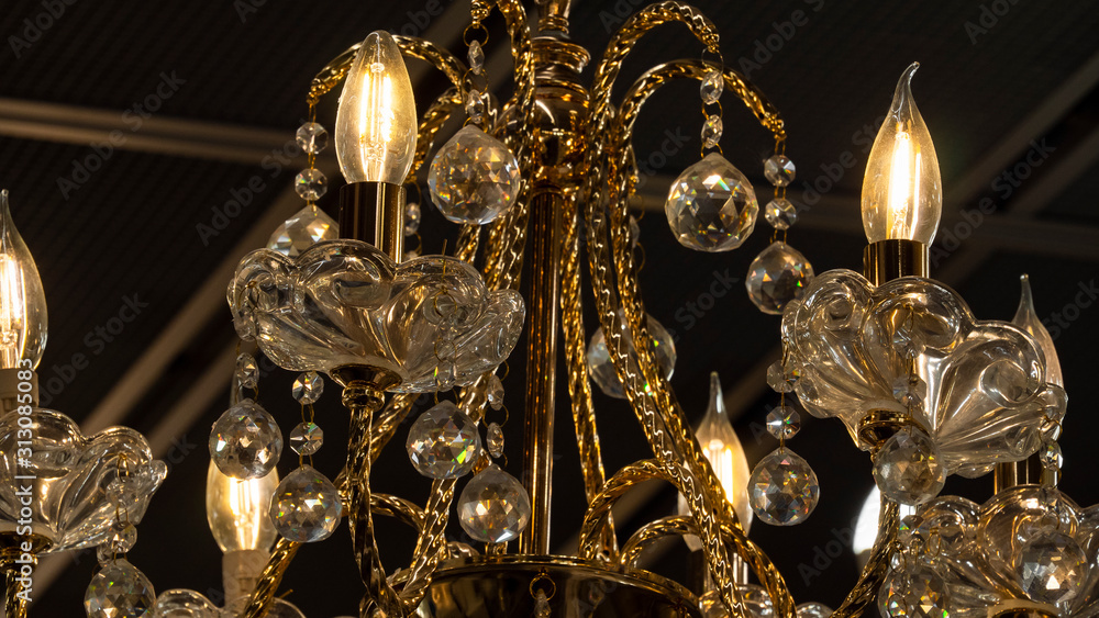 Chandelier.Home, beautiful chandelier.A luxurious lamp hangs from the ceiling.Brass chandelier with crystal.Chandelier ceiling lights, background with copy space. Closeup. Chandelier.Home, beautiful chandelier.A luxurious lamp hangs from the ceiling.Brass chandelier with crystal.Chandelier ceiling lights, background with copy space. Closeup.