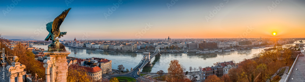 Budapest, Hungary - Aerial panoramic view of Budapest, taken from Buda Castle Royal Palace at autumn sunrise. Szechenyi Chain Bridge, River Danube, Parliament and St. Stephen's Basilica at background