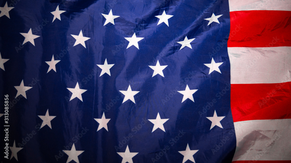 Fototapeta premium American flag. Closeup of United States flag. Over the lying, wavy flag of the United States of America. Red and white stripes.Background.View from above. The concept of patriotism and freedom.