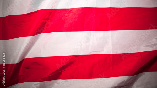 American flag. Closeup of United States flag. The camera flies over the lying, wavy flag of the United States of America. Background.View from above. The concept of patriotism and freedom.