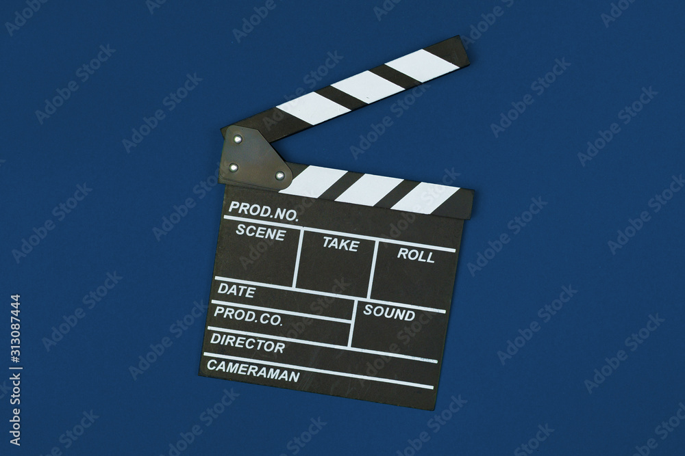 Film clapper board on classic blue background top view