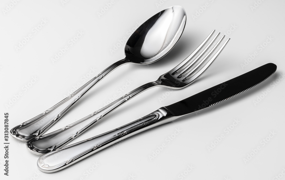 Spoon, fork and knife on a white background