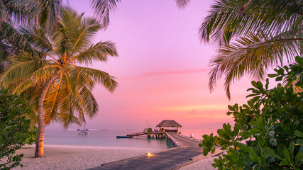 Beautiful sunset beach scene. Colorful sky and clouds view with calm sea and relaxing tropical mood for summer vacation holiday and travel concept