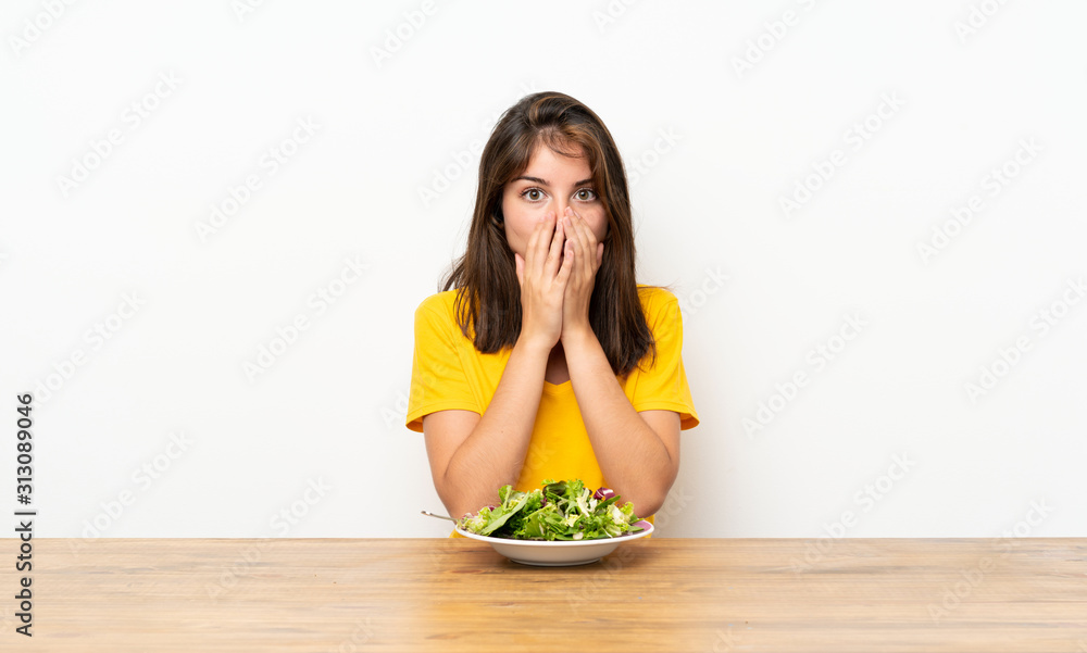Caucasian girl with salad with surprise facial expression Caucasian girl with salad with surprise facial expression