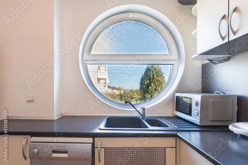 Interior of a kitchen, round window photo