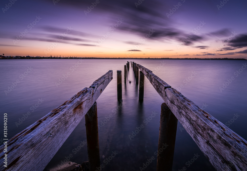 Old wooden jetty leading into the sea
