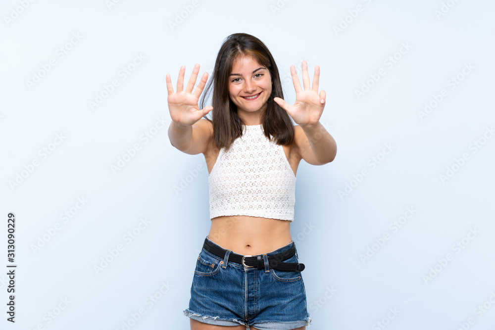 Young woman over isolated blue background counting nine with fingers Young woman over isolated blue background counting nine with fingers