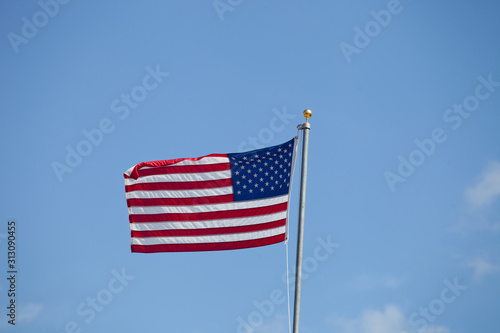Flag of USA waving against blue sky