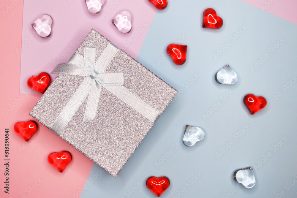 Gift box, on a colorful background with figures of hearts. February 14, Valentine's Day, Mother's Day Gift box, on a colorful background with figures of hearts. February 14, Valentine's Day, Mother's Day