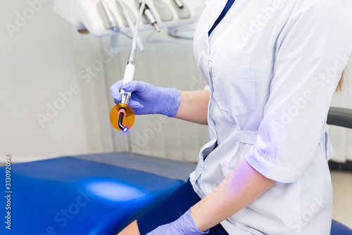 Female doctor uses dental equipment in a hospital office © thomsond