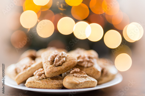 Gingerbread hearts with walnut. Background Abstract blurred light . Christmas concept