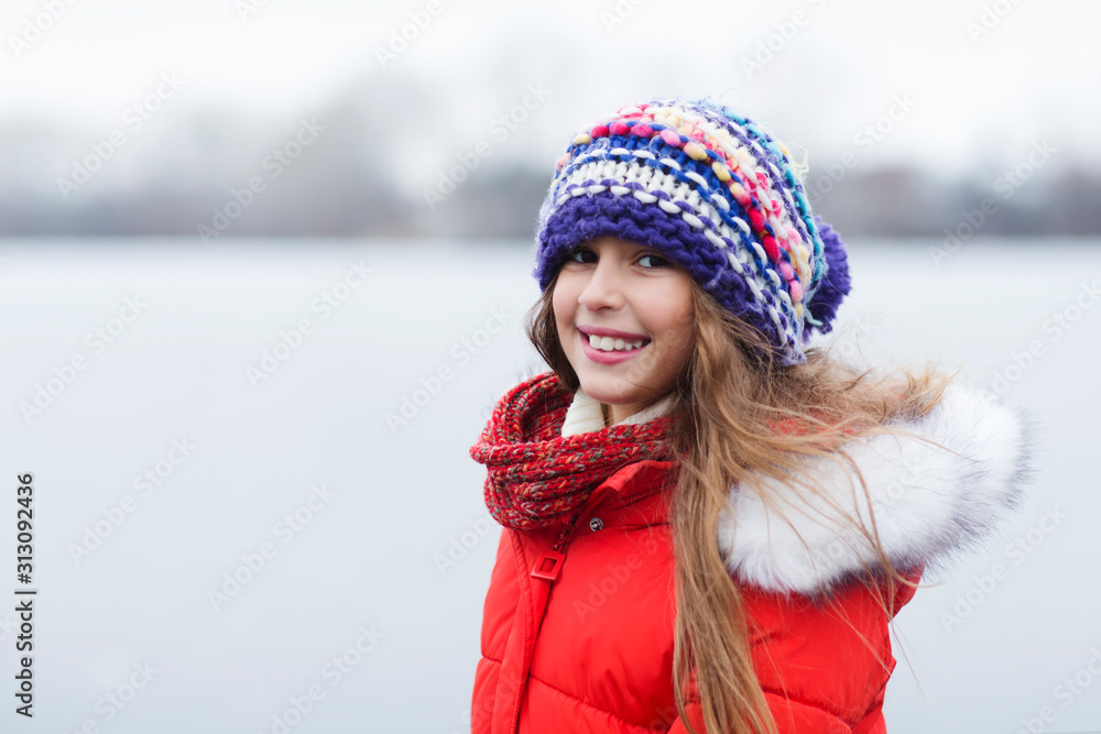 portrait smiling little girl walking on cold winter day. Active winter holydays concept. he joy of missing out. portrait smiling little girl walking on cold winter day. Active winter holydays concept. he joy of missing out.