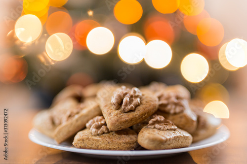 Gingerbread hearts with walnut. Background Abstract blurred light . Christmas concept