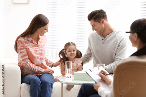 Professional psychologist working with family in office photo