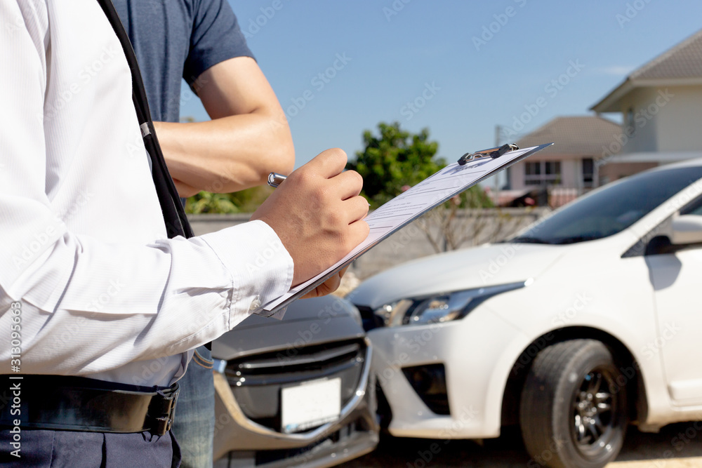 Insurance agents inspect for damage to cars that collide on the road to claim compensation from driving accidents, Insurance concept. Insurance agents inspect for damage to cars that collide on the road to claim compensation from driving accidents, Insurance concept.