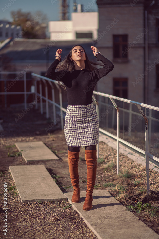 Fototapeta premium Fashion woman portrait of young pretty trendy girl posing at the city in Europe, autumn street fashion.