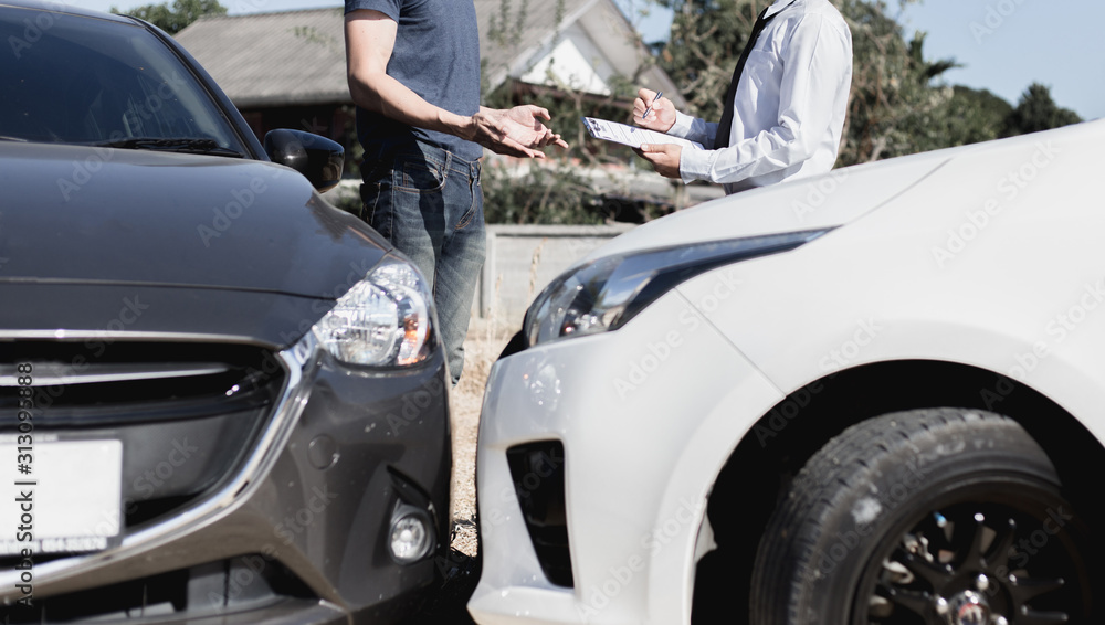 Insurance agents inspect for damage to cars that collide on the road to claim compensation from driving accidents, Insurance concept. Insurance agents inspect for damage to cars that collide on the road to claim compensation from driving accidents, Insurance concept.
