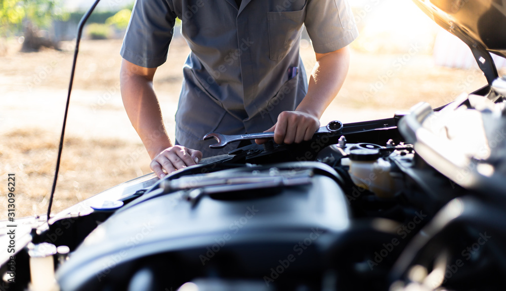 Car mechanic has checked the condition of the engine in wrench, Car repair service concept. Car mechanic has checked the condition of the engine in wrench, Car repair service concept.