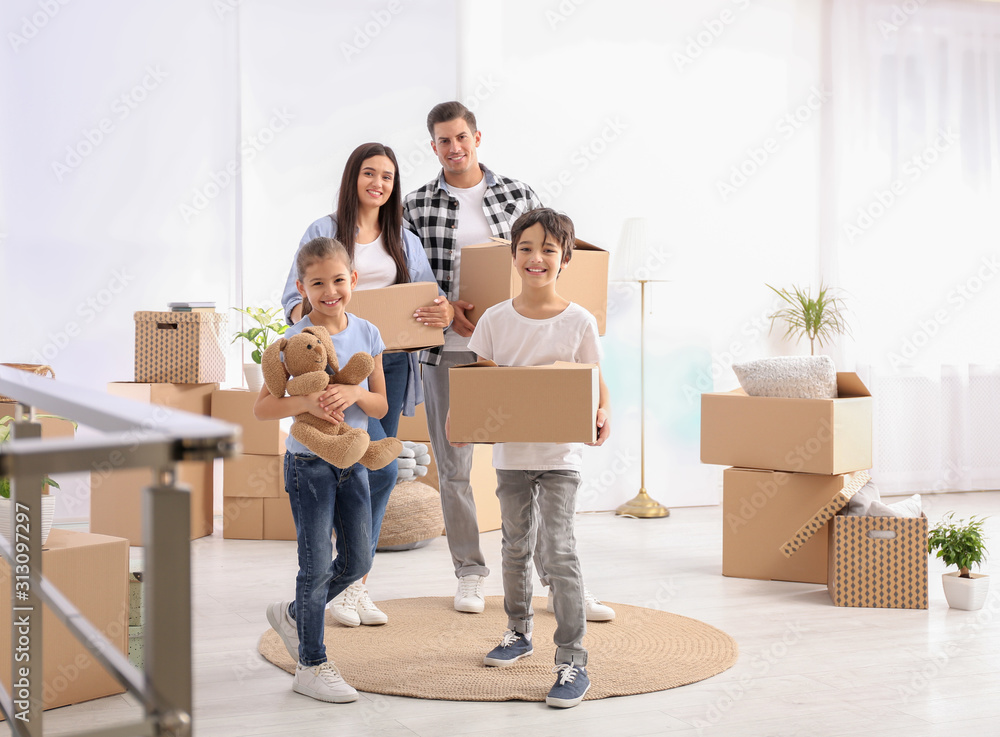 Happy family in room with cardboard boxes on moving day Happy family in room with cardboard boxes on moving day