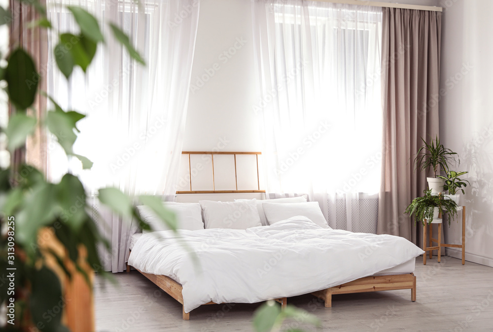 Fototapeta premium Modern interior of stylish room with large bed