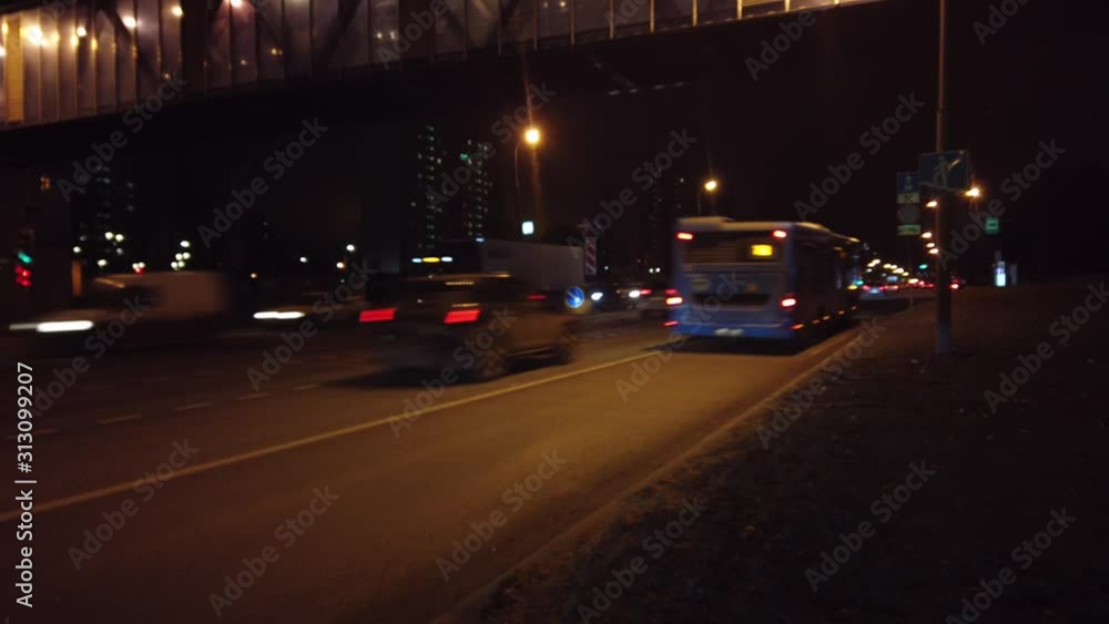Moscow, Russia - DECEMBER 28 2019: Timelapse. Moscow. Cars with headlights driving on the highway in the night, dark evening, Flashlights on street. Moscow, Russia - DECEMBER 28 2019: Timelapse. Moscow. Cars with headlights driving on the highway in the night, dark evening, Flashlights on street.