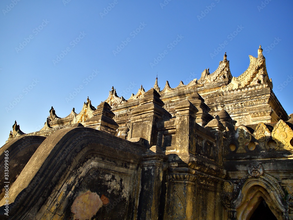 The entrance ladder and the main structure of Maha Aungmye Bonza (MeNu Brick) Monastry in the evening at Inwa, Myanmar