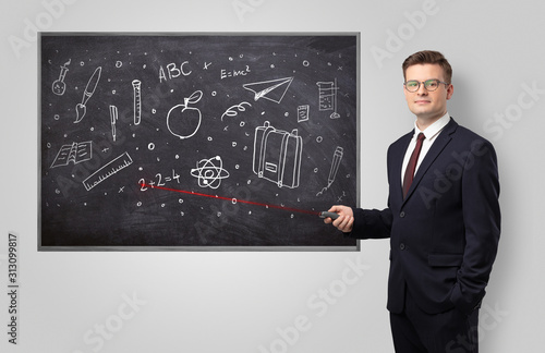 Handsome young teacher with laser pointer teaching