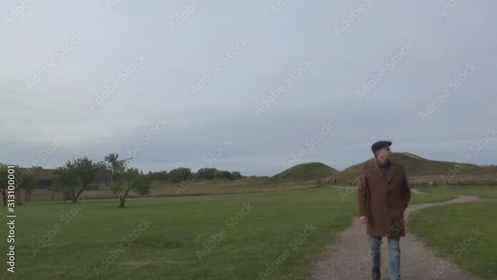 a tourist walking on an old field Uppsala, Sweden a tourist walking on an old field Uppsala, Sweden