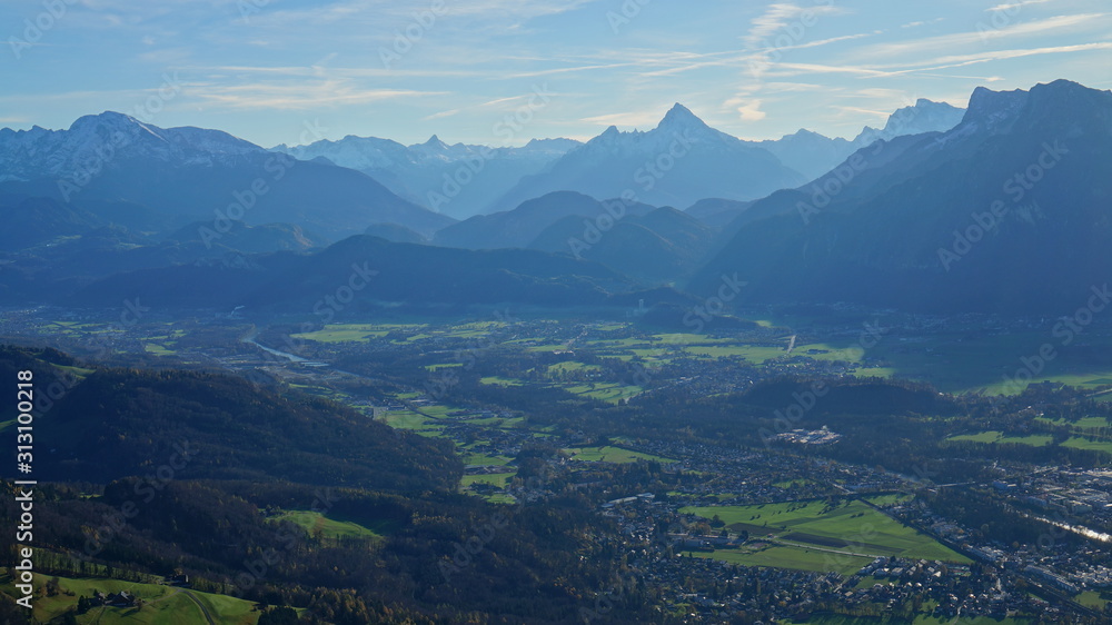 Aerial panoramic view of Salzburg and Alpine mountains from the top of Untersberg mountain in Austria.